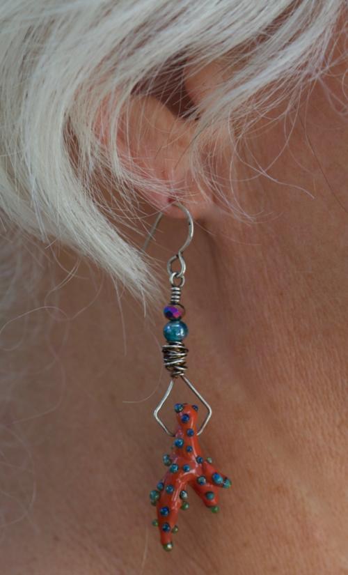 Glass orange coral earrings modeled