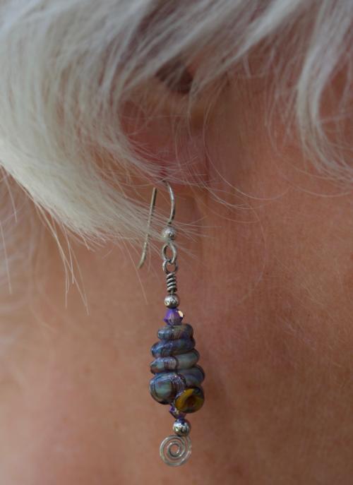 glass spiral seashell earrings on model